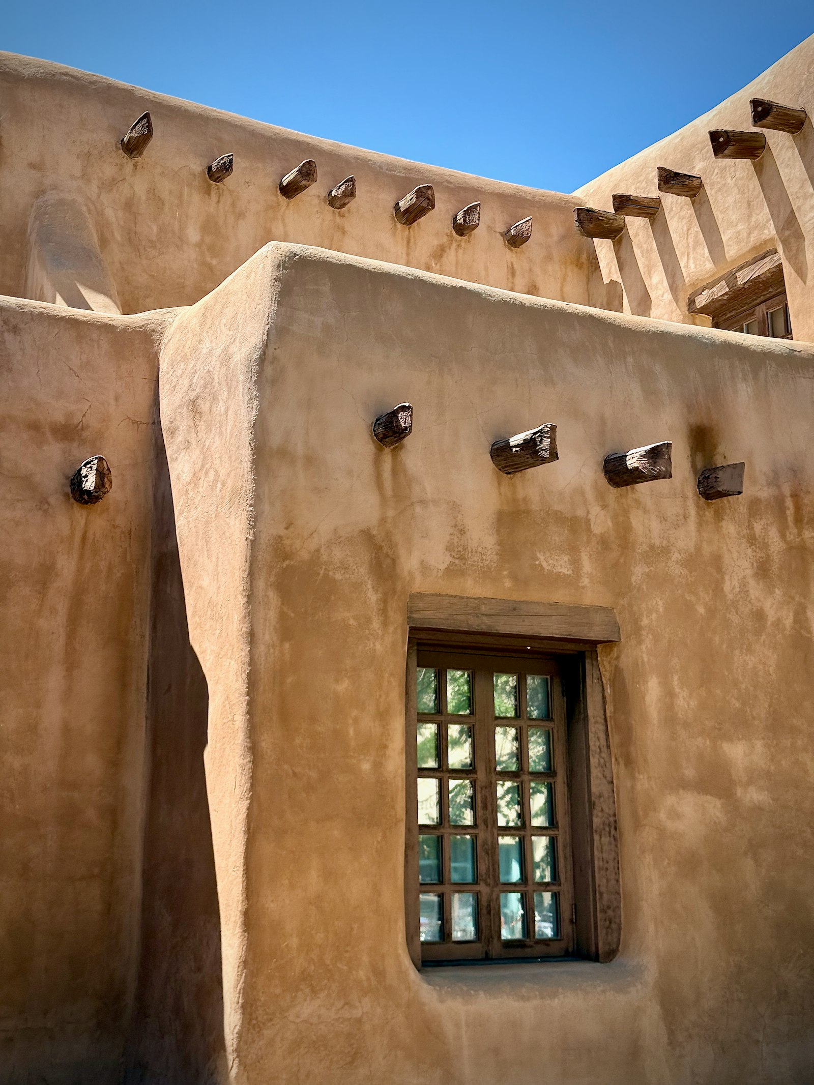 A bright New Mexico living room with new vinyl windows framing a high-desert view